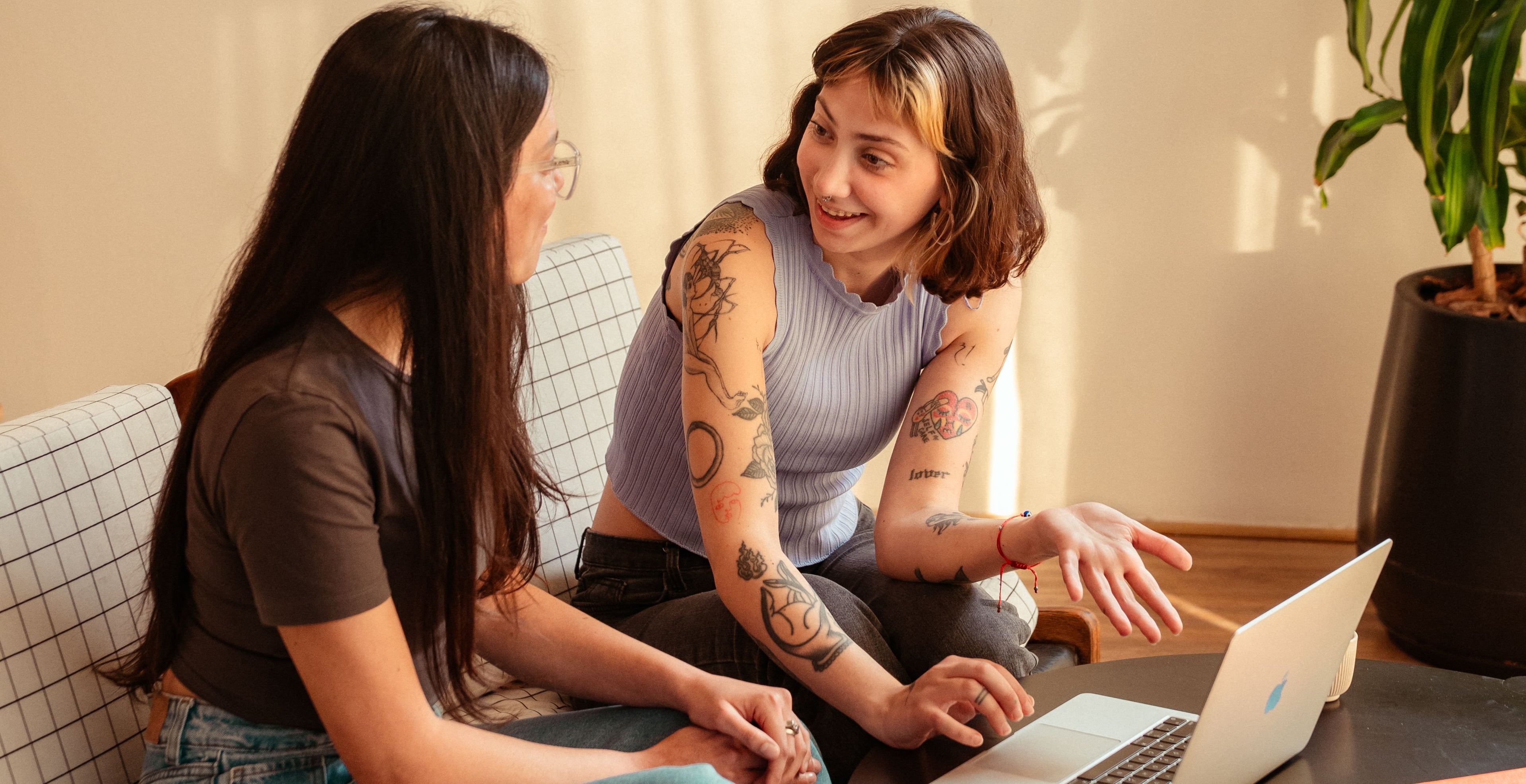 Two Aerolabers working at office couch with their laptops